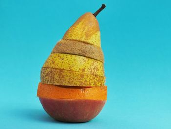 Close-up of fruit slices over blue background