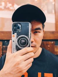 Portrait of man holding camera