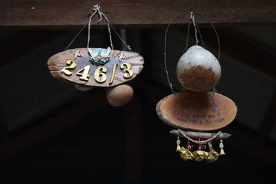 Close-up of toys hanging on wood