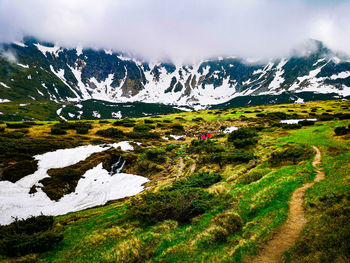 Scenic view of snowcapped mountains against sky - muntii rodnei