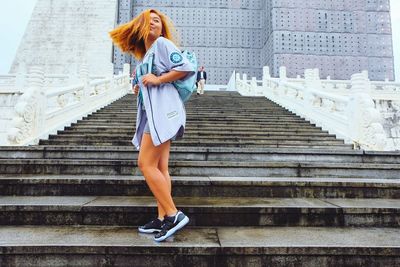 Low angle view of woman standing on steps