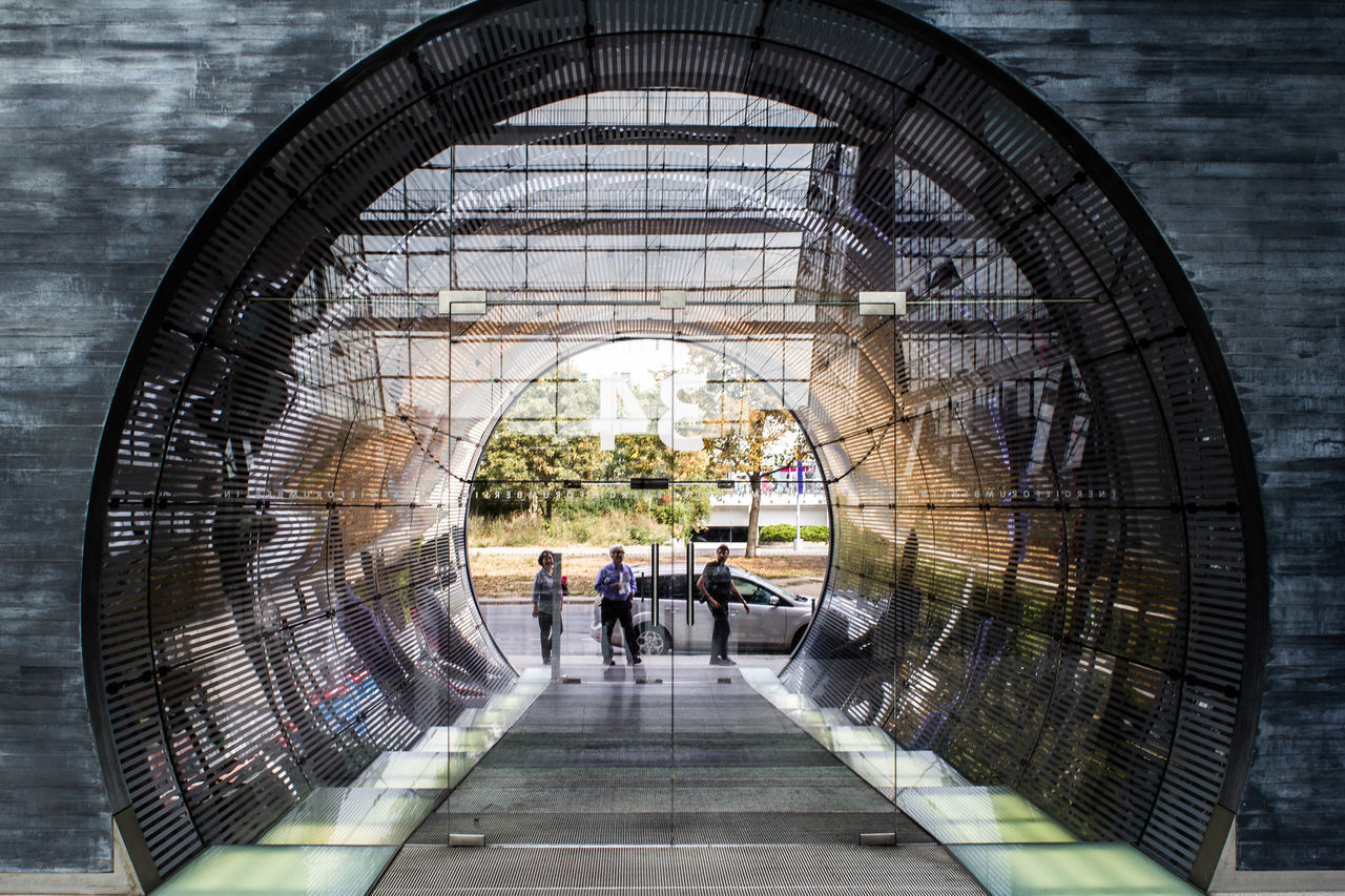 PEOPLE WALKING IN MODERN OFFICE BUILDING