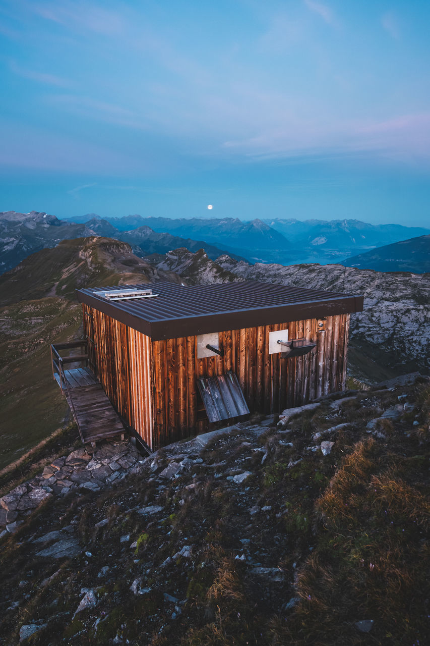 sky, mountain, nature, wood - material, architecture, beauty in nature, scenics - nature, cloud - sky, water, tranquility, built structure, no people, tranquil scene, environment, non-urban scene, landscape, day, outdoors, land