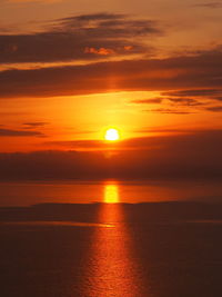 Scenic view of sea against orange sky