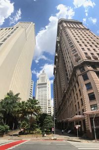 City street amidst modern buildings against sky