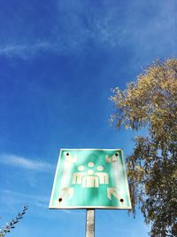 Low angle view of road sign against blue sky