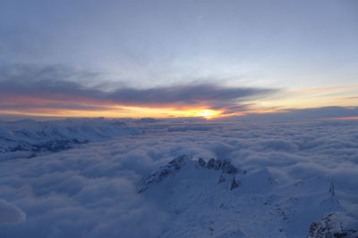Scenic view of snow against sky during sunset