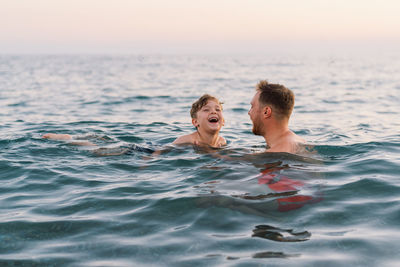 Portrait of boy swimming in sea