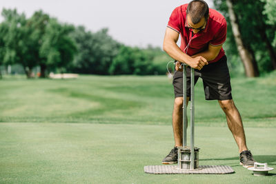 Full length of man standing on golf course