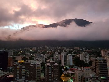 Aerial view of buildings in city against sky