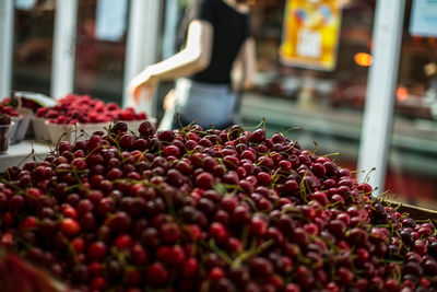 Close-up of fresh cherries heap at market stall