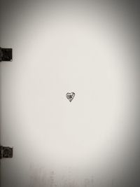 Low angle view of heart shape sign against the sky