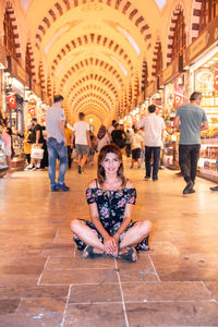 Portrait of smiling woman sitting at mall