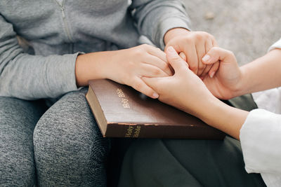 Midsection of couple holding hands