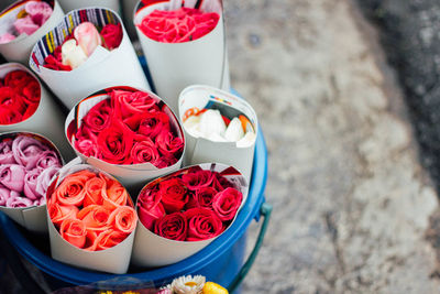 High angle view of roses in bucket at market