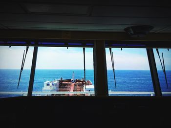 Scenic view of sea against sky seen through window