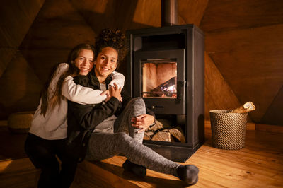 Happy lesbian couple smiling while enjoying indoors.