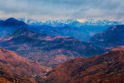 Scenic view of mountains against cloudy sky