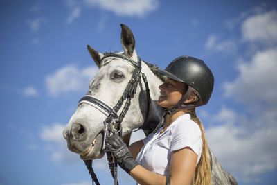 Low section of person riding horse