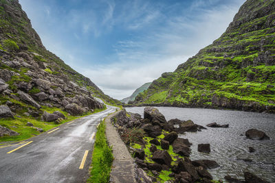 Road amidst rocks against sky