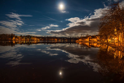 Scenic view of lake against sky at night