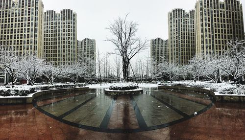 Snow covered cityscape against sky