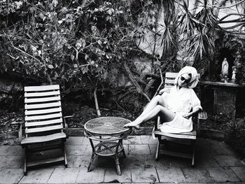 Young woman sitting on tree