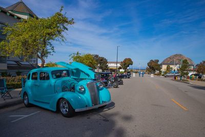 Cars on road against blue sky