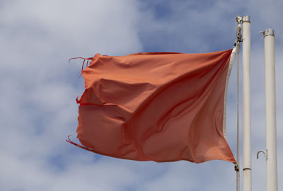 Low angle view of flag against sky