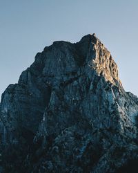 Low angle view of rock formation against clear sky