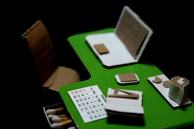 Model of tiny office desk against black background