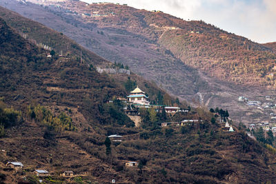 Buddhist monastery situated at mountain foothill at evening 