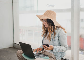 Young woman using laptop while sitting at home