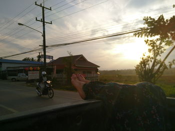 Cars on road against sky during sunset