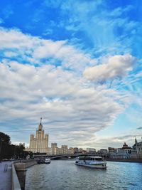 View of building and river against cloudy sky