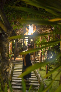 Man sitting on staircase in forest