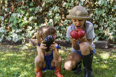 Rear view of man and woman standing against plants