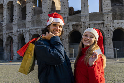 A young couple just bought some christmas presents. 