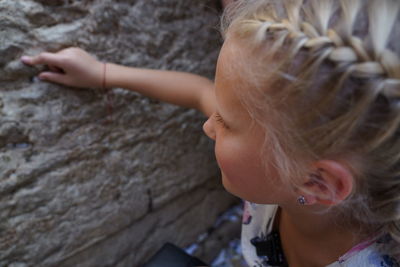 Close-up of girl touching wall