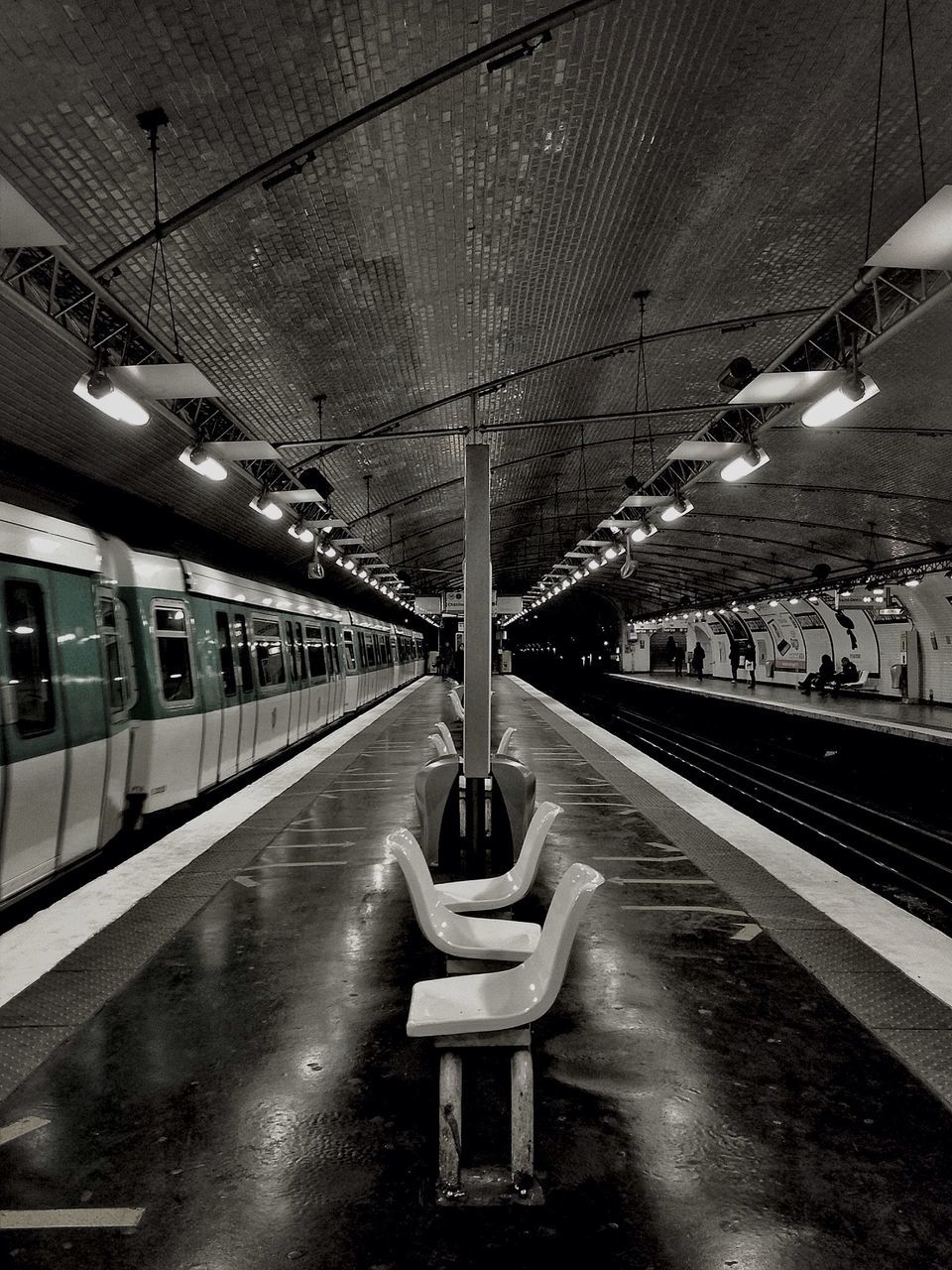 transportation, railroad track, railroad station platform, illuminated, rail transportation, railroad station, public transportation, ceiling, architecture, built structure, indoors, lighting equipment, the way forward, diminishing perspective, incidental people, empty, travel, vanishing point, city, electricity