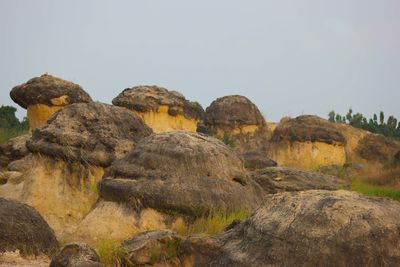 Rock formations on landscape against clear sky