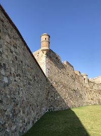 Low angle view of fort against blue sky