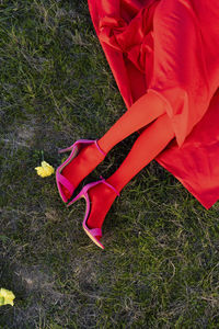 Low section of woman standing on field