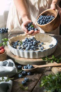 Midsection of woman holding food on table