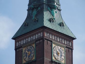 Low angle view of clock tower against sky