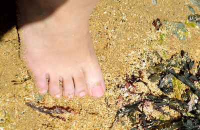 Close up of girls foot  on beach