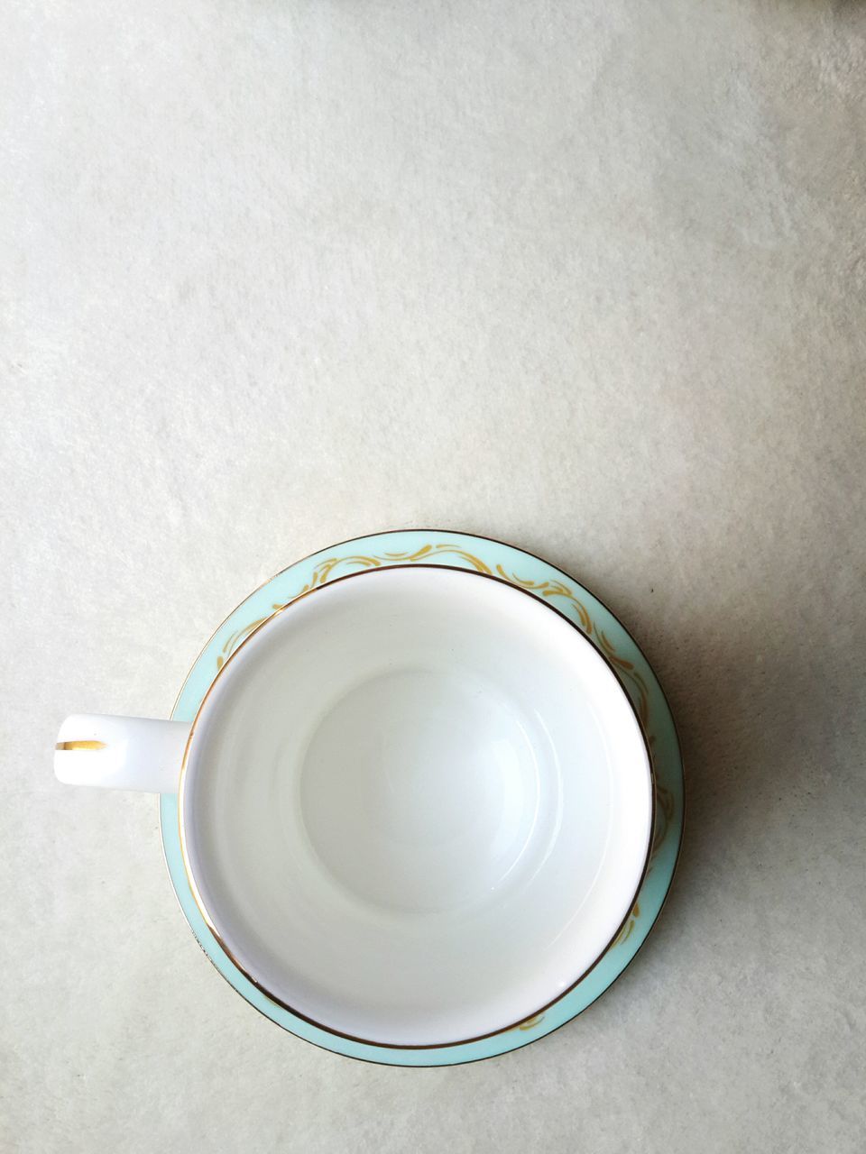 indoors, coffee cup, drink, still life, table, coffee - drink, refreshment, saucer, high angle view, food and drink, cup, directly above, spoon, coffee, close-up, no people, freshness, tea cup, container, tea