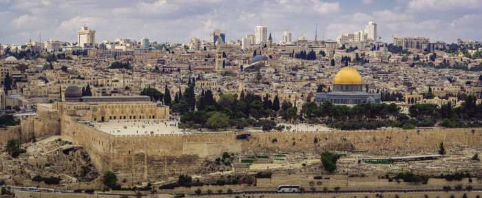 Panoramic view of buildings in city against sky