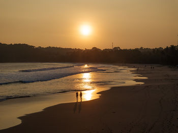 Scenic view of beach against sky during sunset