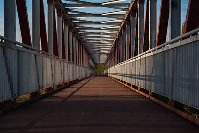 Narrow footbridge along railings